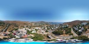 an aerial view of a resort on a hill next to the water at Panorama Hotel Bodrum in Golturkbuku