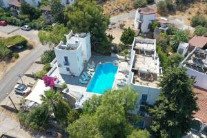 an aerial view of a house with a swimming pool at Panorama Hotel Bodrum in Golturkbuku