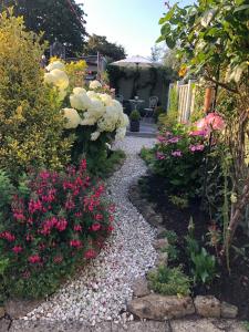 a garden with colorful flowers and a walkway at Cottage in the heart of Montacute in Montacute