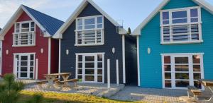 two colorful houses with a picnic table in front of them at Domki Primore in Władysławowo