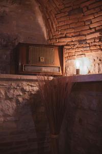 a vase sitting on a shelf in a stone room at Gites chez Antonin in Tour-de-Faure