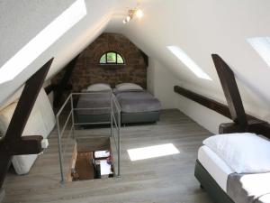 ミヒェルシュタットにあるEinfache Unterkunftの屋根裏のベッドルーム(ベッド2台、階段付)