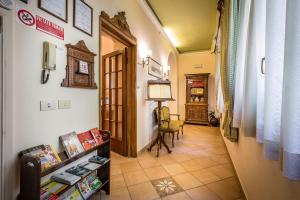 a hallway with a table and a chair in a room at Casa di Barbano in Florence