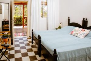 a bedroom with a bed and a checkered floor at Shaar Hagolan Kibbutz Country Lodging in Shaar Hagolan