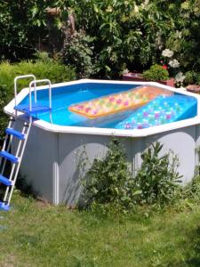 a swimming pool with a ladder in a backyard at Can MiA in Bas