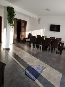 une salle à manger avec une table, des chaises et un tapis dans l'établissement Casa Nagy, à Sovata