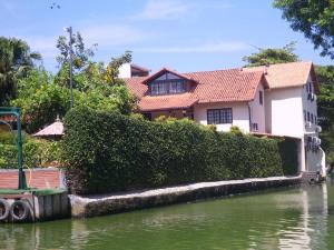 a house on the water next to a river at Residencial Gigoia Inn in Rio de Janeiro