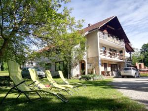 un groupe de chaises de jardin devant un bâtiment dans l'établissement Lazy Bear, aux lacs de Plitvice
