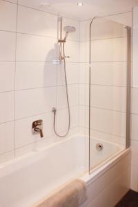 a bathroom with a shower and a bath tub at Lutonia Appartements Sölden in Sölden +55 photos