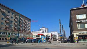 a city street with buildings and a person riding a bike at Kouvola Apartment in Kouvola