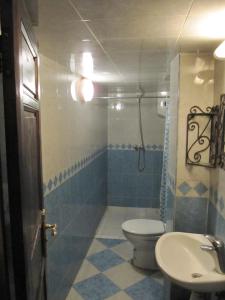 a bathroom with a shower, sink, and toilet at Sindi Sud in Marrakesh
