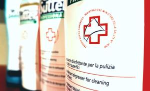 a container of medicines with a red cross logo on it at Hotel La Scaletta in Lido di Ostia