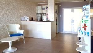 a waiting room with a counter and a chair at Hotel La Scaletta in Lido di Ostia