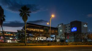 a city at night with a street light and buildings at Candlewood Suites - Queretaro Juriquilla by IHG in Querétaro
