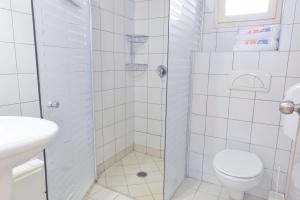 a bathroom with a shower with a toilet and a sink at HI - Massada Hostel in Ein Bokek