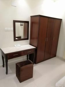 a bathroom with a sink and a vanity with a mirror at Dar Karim in Abha