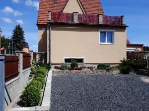 a house with a balcony on top of it at Apartment Patera in Unhošť