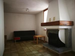 a living room with a fireplace and a couch at Rustico Il Pardo in Maggia