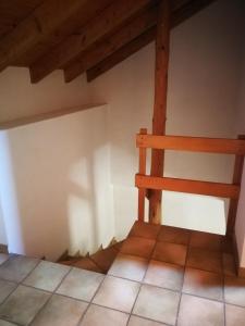 a corner of a room with a wooden chair at Rustico Il Pardo in Maggia