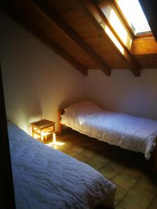 a bedroom with two beds and a skylight at Rustico Il Pardo in Maggia