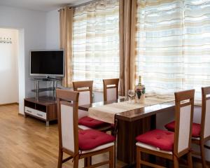 a dining room with a table with chairs and a television at Ferienhaus Prasl in Jagerberg