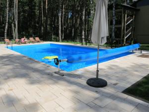 a swimming pool with a blue pool noodle next to it at apartament37.pogorzelica in Pogorzelica