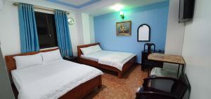 Giường trong phòng chung tại Thanh Lan Hotel