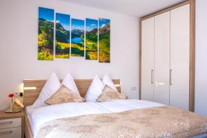 a bedroom with a bed with mountains in the background at Apartments Davydov in Bad Hofgastein