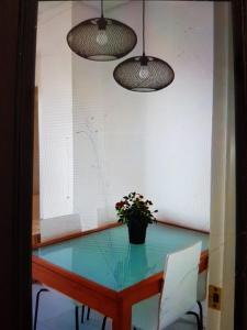 a table with two chairs and a potted plant on it at Apartamento primera linea junto al puerto in Denia