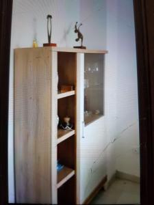 a wooden cabinet in a room with a wall at Apartamento primera linea junto al puerto in Denia