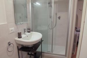 a bathroom with a sink and a shower at CIRIBACCO ROOMS in Macerata +17 photos