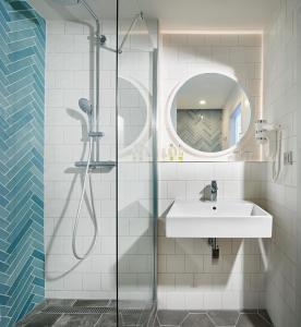 un bagno con lavandino e doccia di OREA Resort Santon Brno a Brno