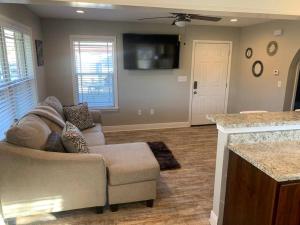 a living room with a couch and a tv at Villas at Valencia Bay in Gulfport