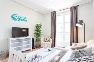 A television and/or entertainment centre at Boutique Apartments in the Heart of Madrid