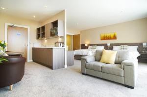 a room with a couch and a bed and a kitchen at Bannview Bed & Breakfast in Portadown