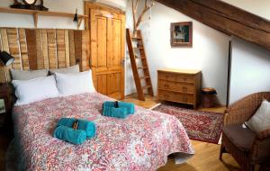 a bedroom with a bed with two blue pillows on it at ESPERIA casa vacanza in Trieste