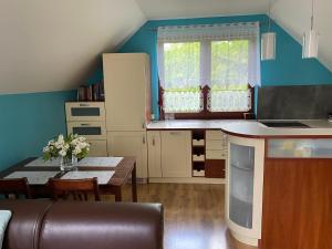 a kitchen with a table and a dining room at Apartament w Twardorzeczce in Sienna