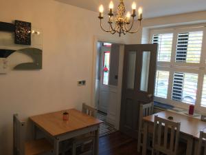 a dining room with a table and a chandelier at Lisheen Lodge in Galway