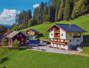a house on top of a green hill at Grassbichlhof in Altenmarkt im Pongau