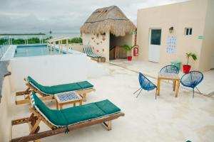a patio with chairs and a swimming pool at Corazon Mexicano Holbox in Holbox Island