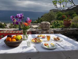 a white table with plates of food on it at Konaku Guest house in Gjirokastër