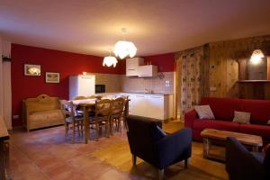 a kitchen and living room with a table and a couch at Maison Peroulaz in Charvensod +30 photos