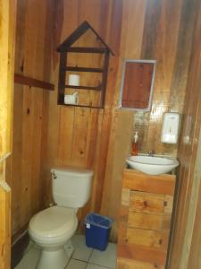 a bathroom with a toilet and a sink at Hostal Oasis The Traveler in Lanquín