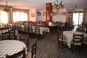 a dining room filled with tables and chairs with checkered tables at Raco d'en Pepe in Calella