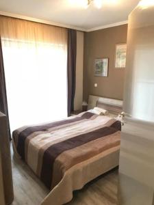 Een bed of bedden in een kamer bij Relax Apartmenthouse