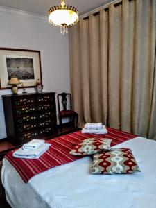 a bedroom with a bed with two towels on it at Páteo memória, casa do beco in Setúbal