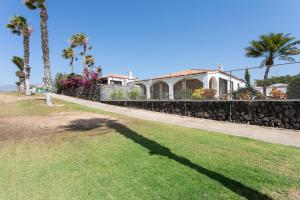 a shadow on the grass in front of a house at CASA GOLF beautiful views with private pool in San Miguel de Abona