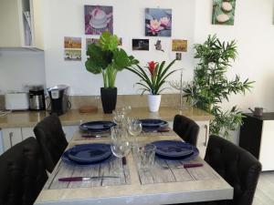 a table with plates and glasses on top of it at 9 Avenue de Carras in Nice