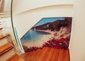 a picture of a beach on a wall at Mare DiVino in Porto Recanati