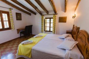 a bedroom with a large bed with yellow sheets at Hostal Villa Verde-Adults Only in Deia